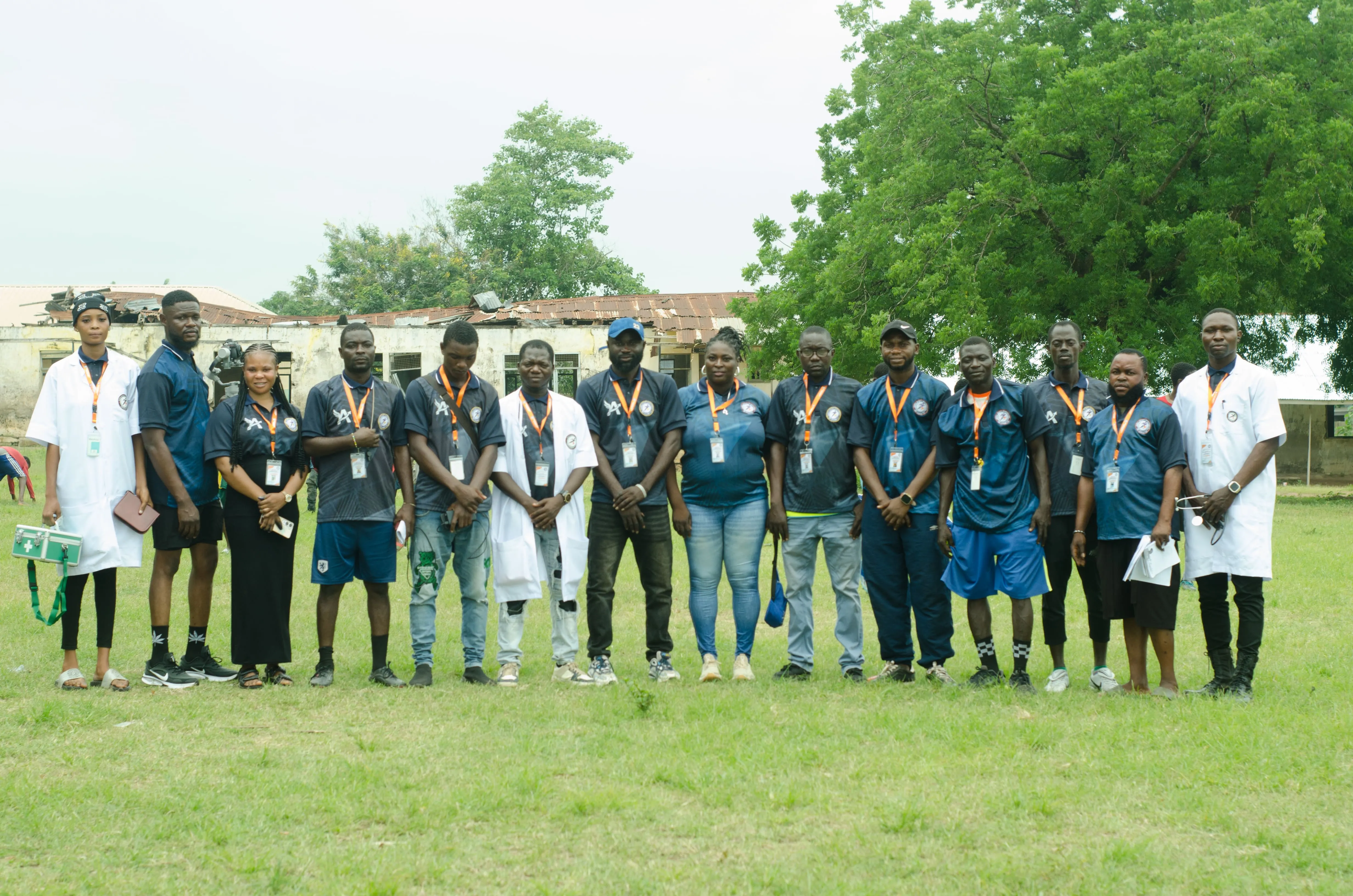 Academy staff and leaders gathered beside the pitch