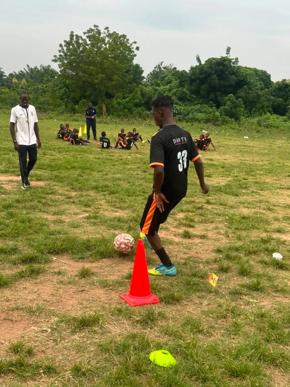 A Dante player controlling the football beside a training cone