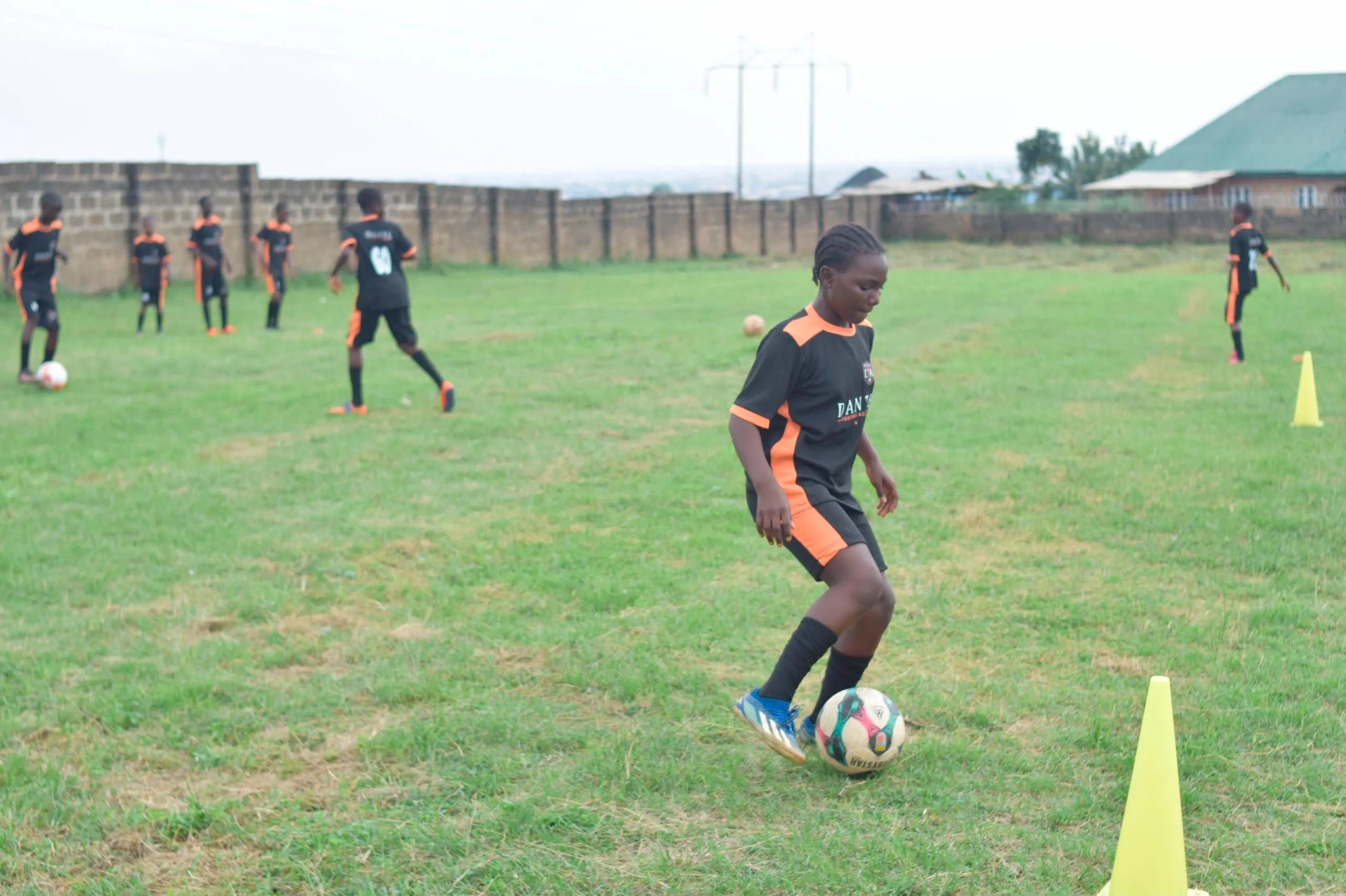 Dante academy players competing for the football during an intense session