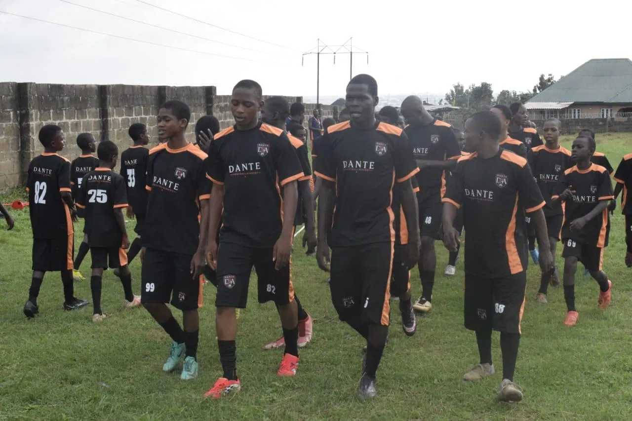 Dante players walking together across the academy pitch