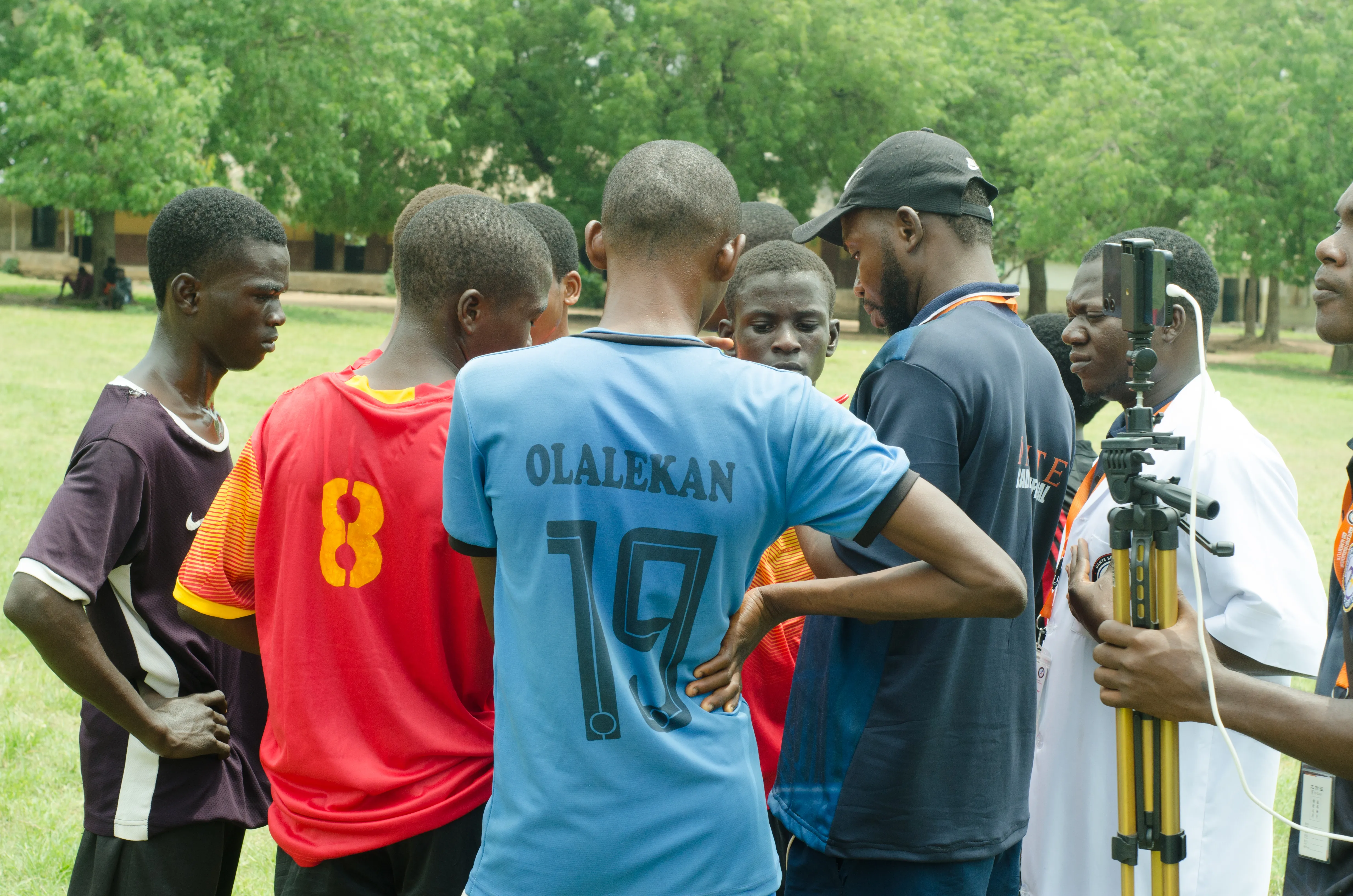 A Dante coach speaking with young players during a training session